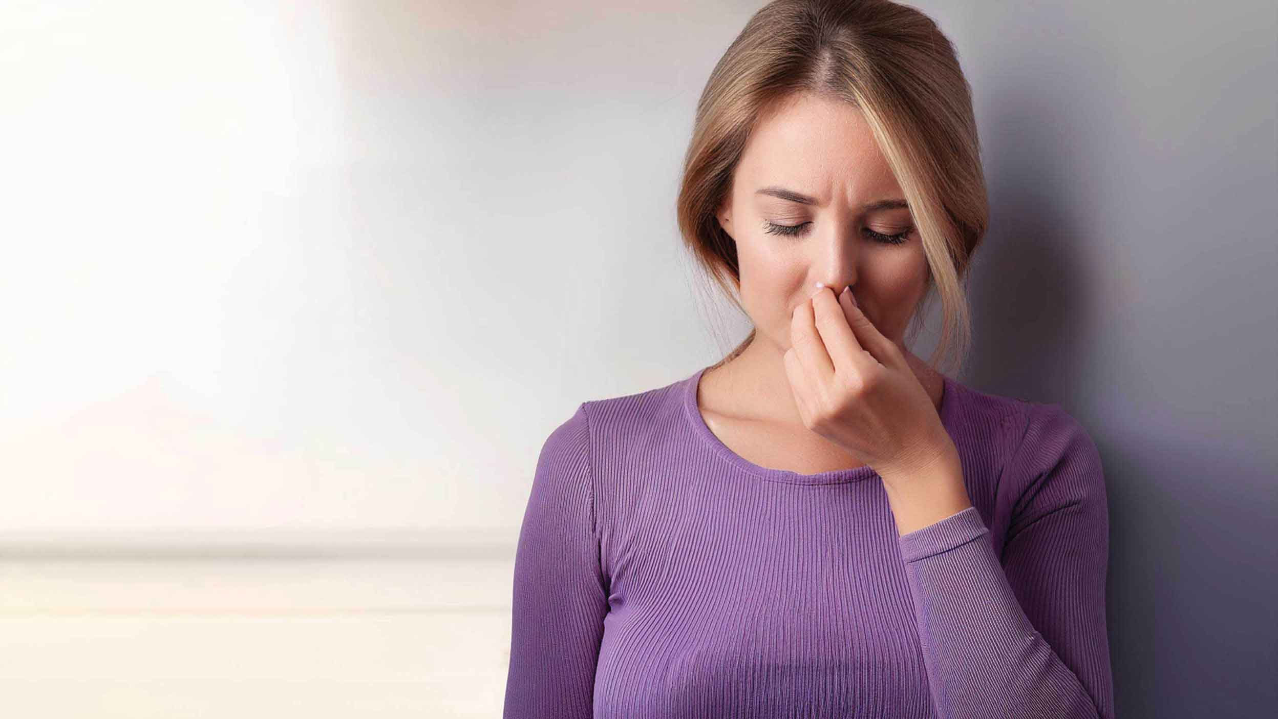 Woman pinching her nose